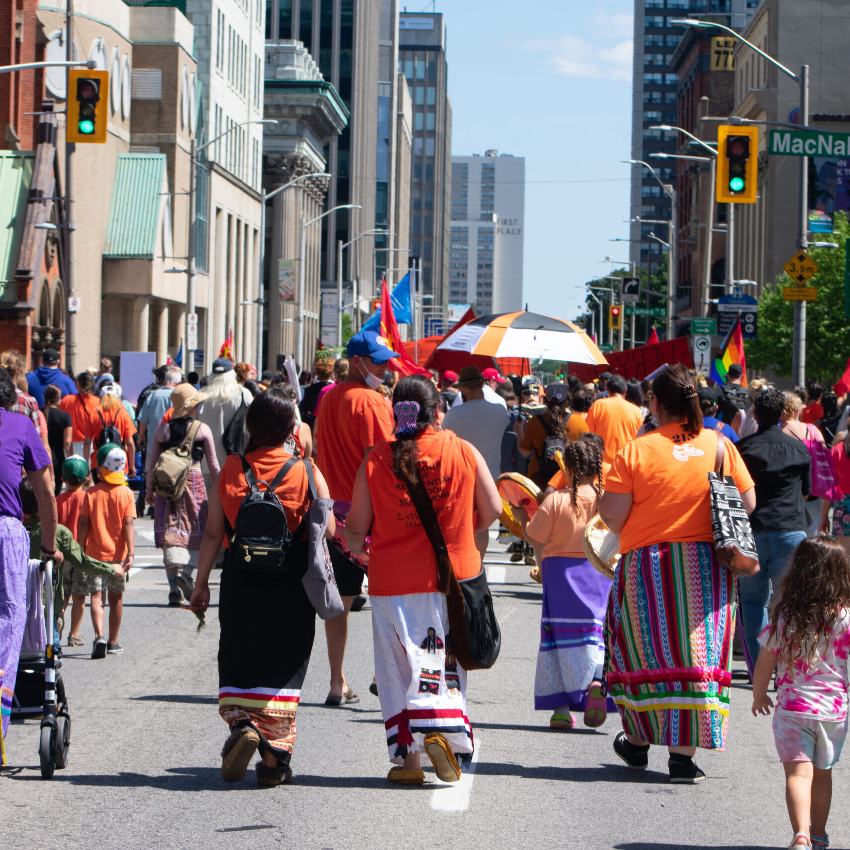 A group of people walking down the road at a festival